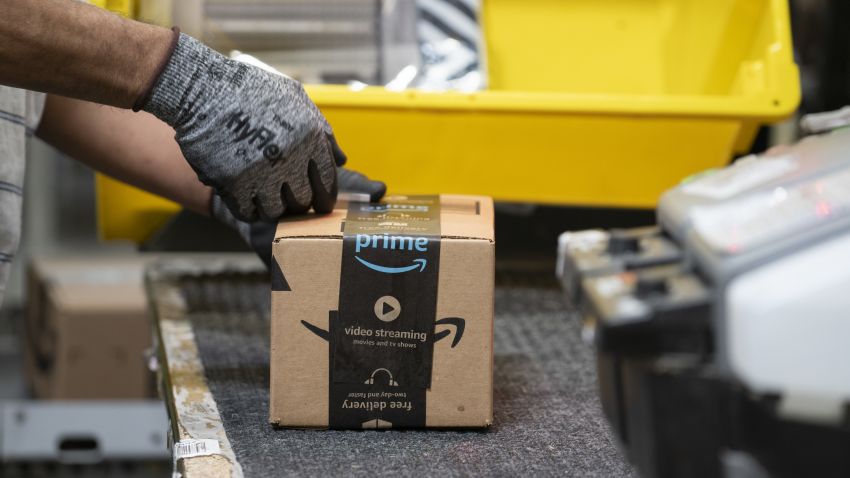 An employees places a label on a box at the Amazon.com Inc. fulfillment center in Baltimore, Maryland, U.S., on Tuesday, April 30, 2019. Amazon.com will spend $800 million in the current quarter to reduce delivery times for top customers to one day from two, trying to revive its main e-commerce franchise and ward off greater competition. Photographer: Melissa Lyttle/Bloomberg via Getty Images