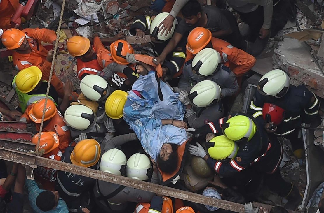 Emergency personnel rescue a survivor from the rubble.