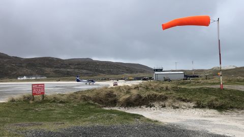 The windsock flies in a strong breeze at Traigh Mhòr beach. 
