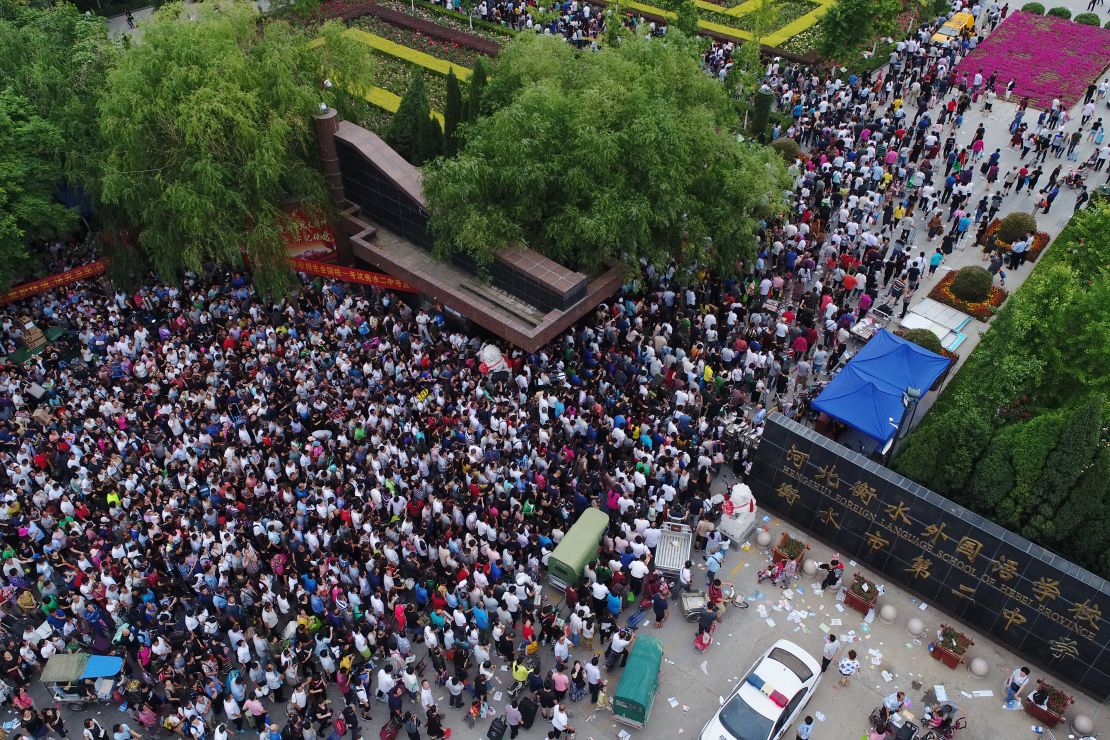 Parents wait for their children to finish the National College Entrance Examination (aka Gaokao) at Hengshui No.2 High School on June 8, 2018 in Hebei.