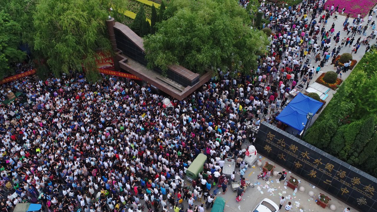 Parents wait for their children to finish the National College Entrance Examination (aka Gaokao) at Hengshui No.2 High School on June 8, 2018 in Hebei.