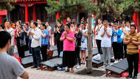Parents pray for high marks for their children who take the National College Entrance Examination (aka Gaokao) at Ci'en temple on June 7, 2018 in Shenyang.