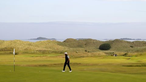 Tiger Woods walks onto a green during practice for The Open at Royal Portrush.