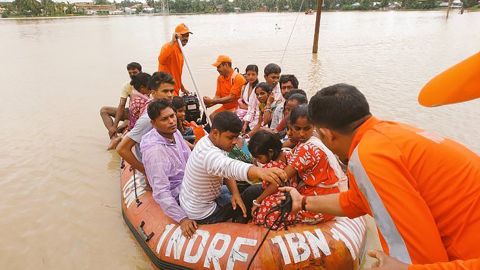 Indian officials carry out evacuations in flooded Golghat, in India's northeastern Assam state.