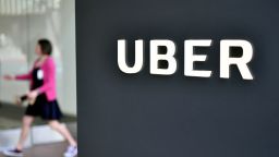 A woman walks into the Uber Corporate Headquarters building in San Francisco, California on February 05, 2018. - The billion-dollar trial pitting Alphabet-owned autonomous driving unit Waymo against Uber started in what could be a blockbuster case between two technology giants over alleged theft of trade secrets. The San Francisco courtroom battle will take place as Waymo and Uber race to perfect self-driving cars that people could summon for rides as desired in a turn away from car ownership. (Photo by JOSH EDELSON / AFP)        (Photo credit should read JOSH EDELSON/AFP/Getty Images)