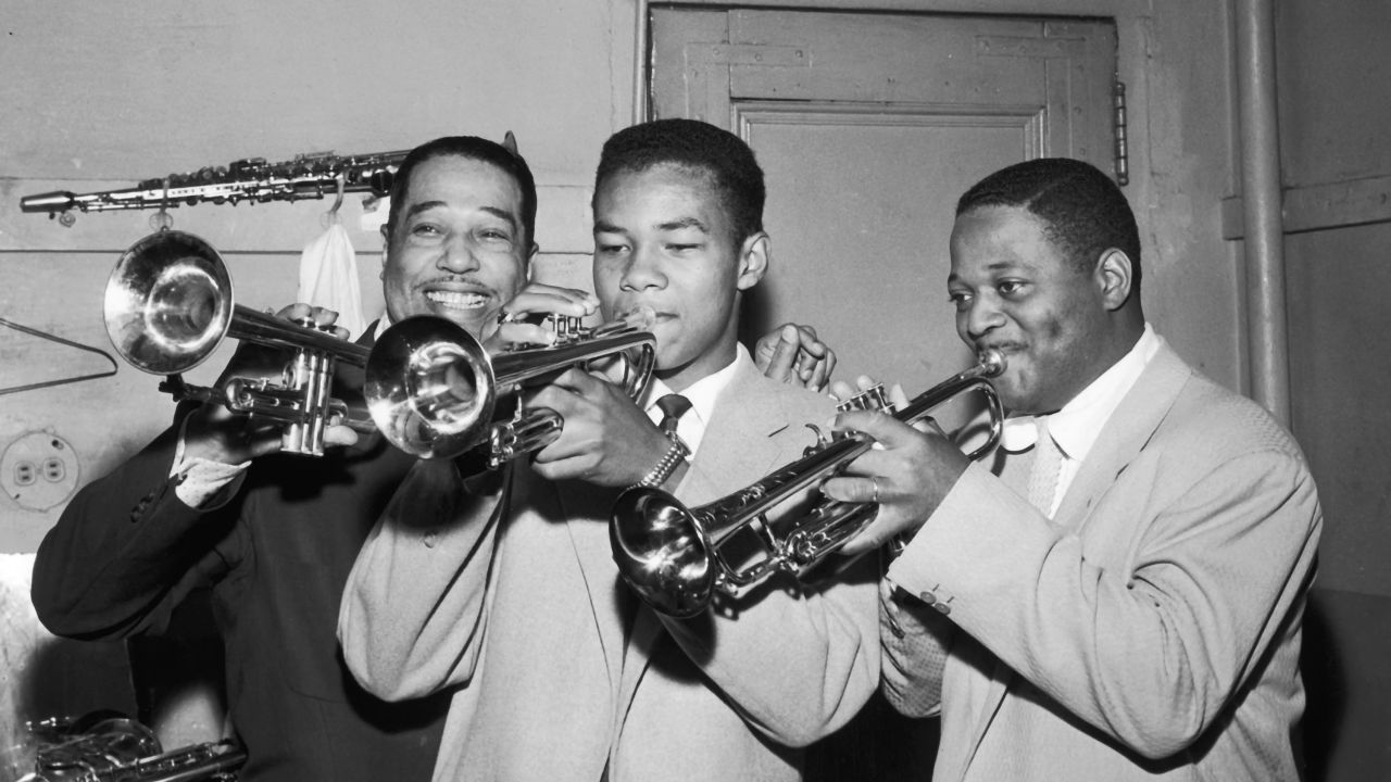 Clark Terry plays the trumpet with his son Rudolph and Duke Ellington in 1955.