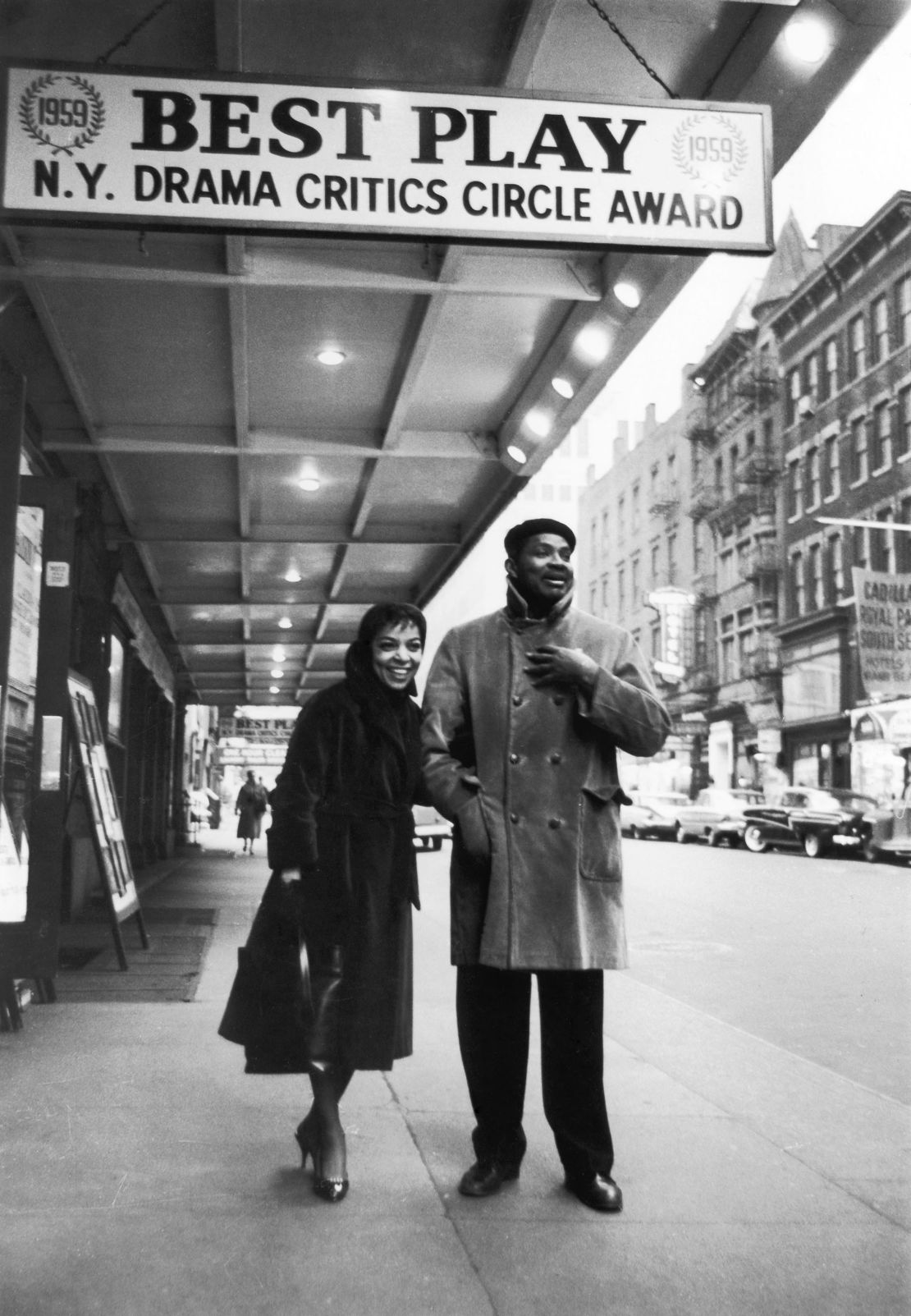 Ruby Dee and Ossie Davis stand outside of a theater in 1959.