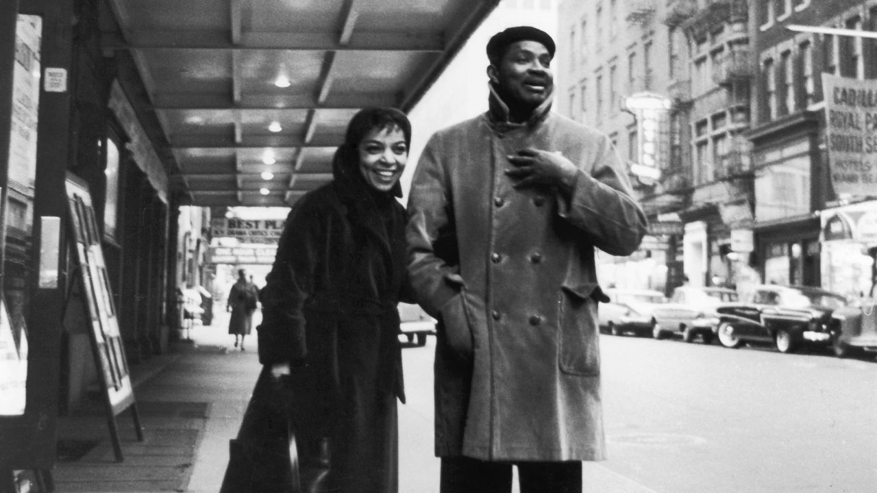 Ruby Dee and Ossie Davis stand outside of a theater in 1959.