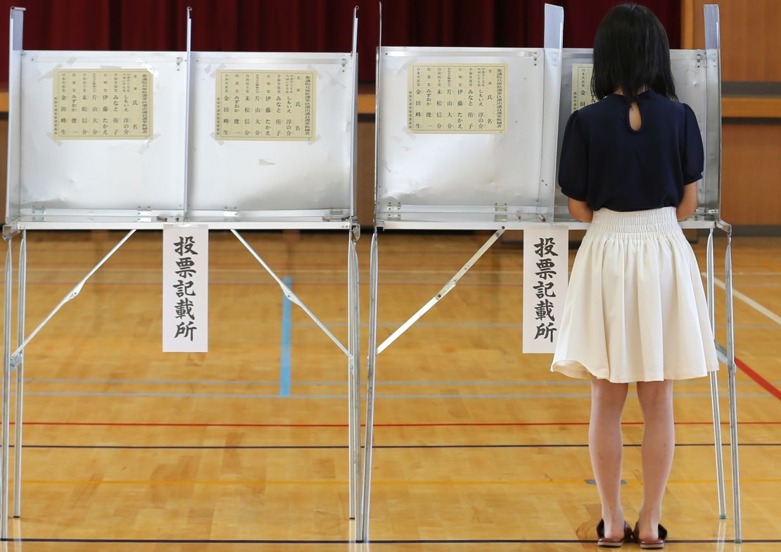 An 18-year-old woman casts her vote for parliament's upper house election at a polling station on July 10, 2016 in Himeji, Japan.