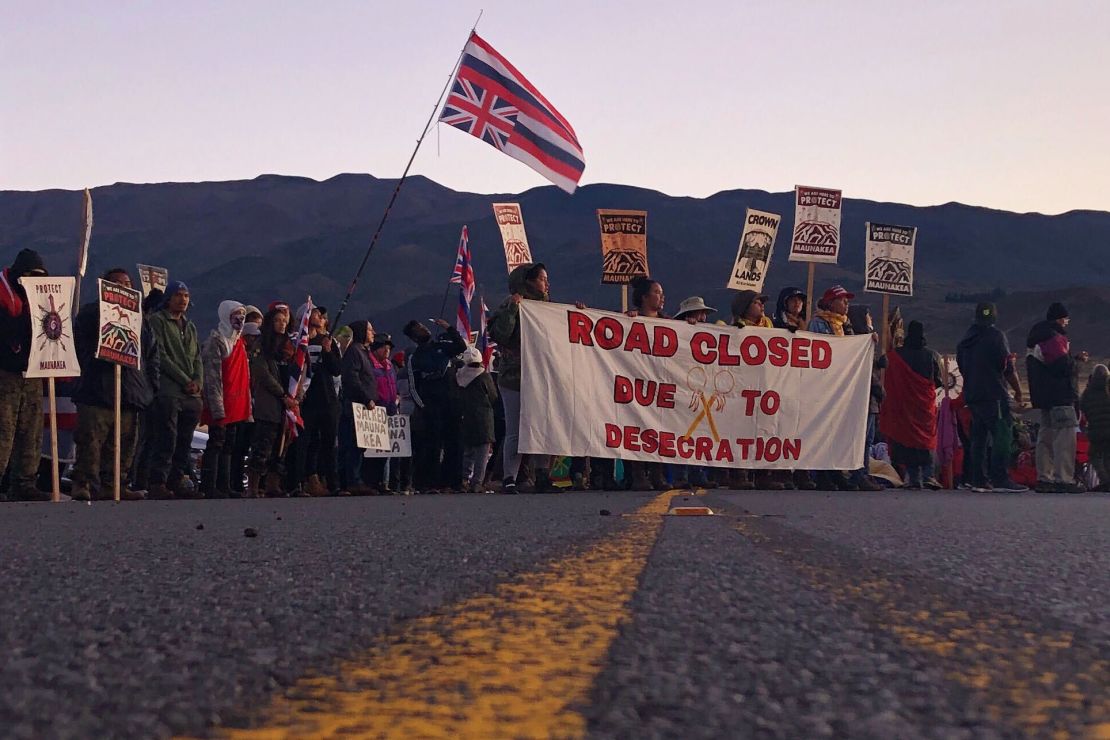 Demonstrators gather to block a road at the base of Hawaii's tallest mountain, Monday, July 15, 2019.