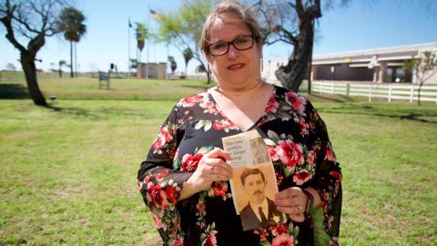 Christine Molis holds a photo of her slain relative.