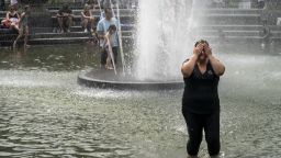 NEW YORK, NY - JULY 17: A woman cools off in the fountain at Washington Square Park during a hot afternoon day on July 17, 2019 in New York City. Sweltering heat is moving into the New York City area, with temperatures expected to rise close to 100 degrees by this weekend. The large heat wave will affect close to two thirds of the United States, with the East Coast and Midwest seeing the worst conditions. (Photo by Drew Angerer/Getty Images)