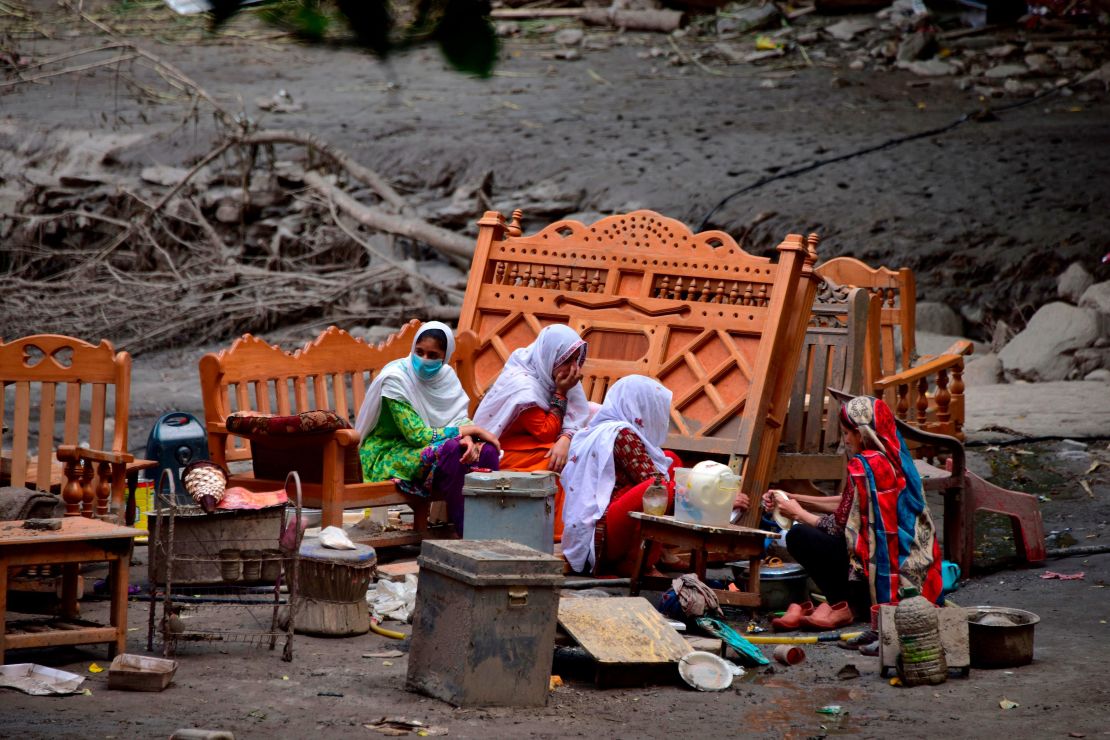 A family in Pakistan-controlled Kashmir outside their damaged house on July 16, 2019.