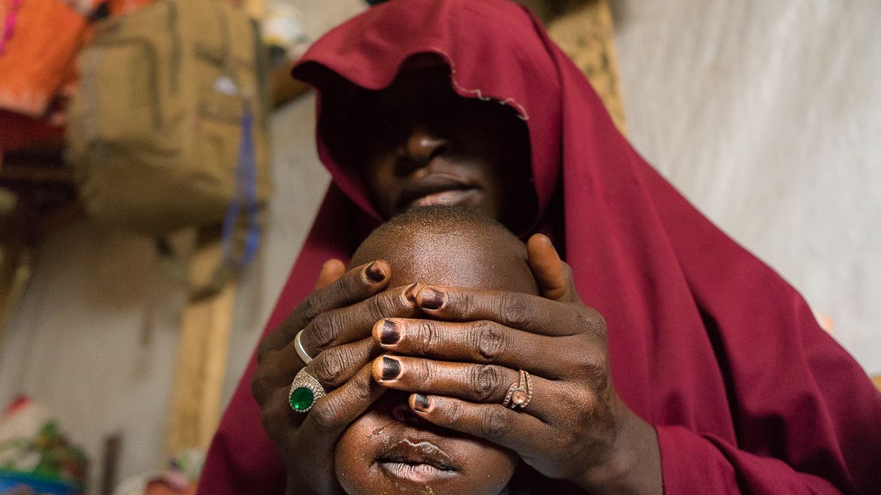 Falamatu, 35, with her son. She gave up her 12 year old daughter, Innakaru to marry a Boko Haram foot soldier. "The insurgents had seized my hometown Bama in Borno State. I live in regret, I pray my daughter Innakaru is safe and will forgive me"- Maiduguri, 2018
