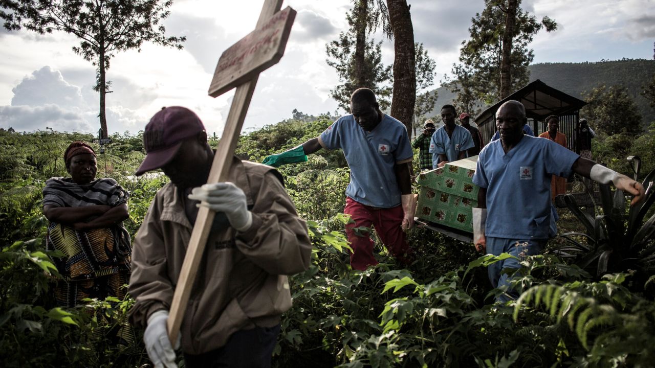 Health workers carry a coffin containing the body of an Ebola  victim in Butembo, Democratic Republic of Congo.  