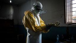 TOPSHOT - A health worker puts on his personal protective equipment (PPE) before entering the red zone of a MSF (Doctors Without Birders) supported Ebola Treatment Centre (ETC), where he will check up on patients on November 6, 2018 in Bunia, Democratic Republic of the Congo. - The death toll from an Ebola outbreak in eastern Democratic Republic of Congo has risen to more than 200, the health ministry said on November 10, 2018. (Photo by John WESSELS / AFP)        (Photo credit should read JOHN WESSELS/AFP/Getty Images)