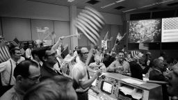 verall view of the Mission Operations Control Room in the Mission Control Center at the Manned Spacecraft Center showing the flight controllers celebrating the successful conclusion of the Apollo 11 lunar landing mission on Jul 24, 1969.Credits: NASA