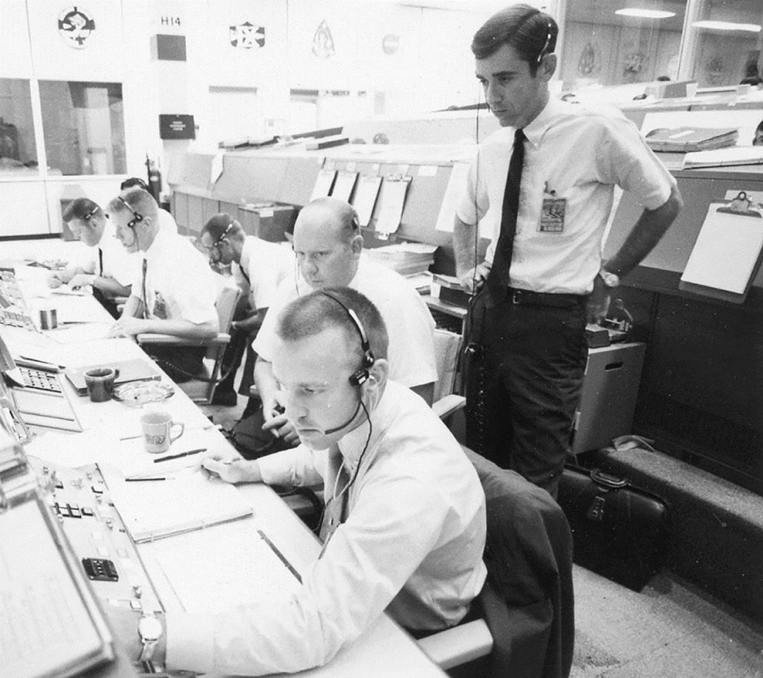 The Apollo 11 flight dynamics team included Jerry Bostick, seen here standing behind Philip Shaffer and David Reed.