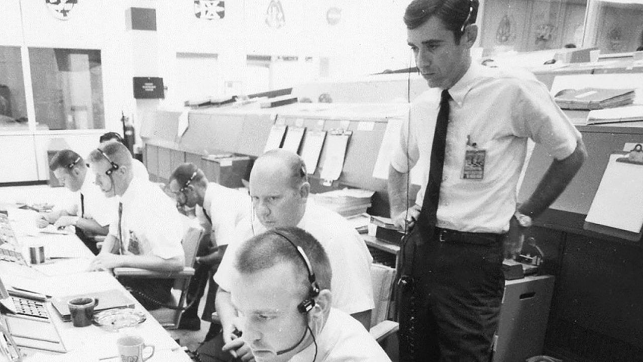 The Apollo 11 flight dynamics team included Jerry Bostick, seen here standing behind Philip Shaffer and David Reed.