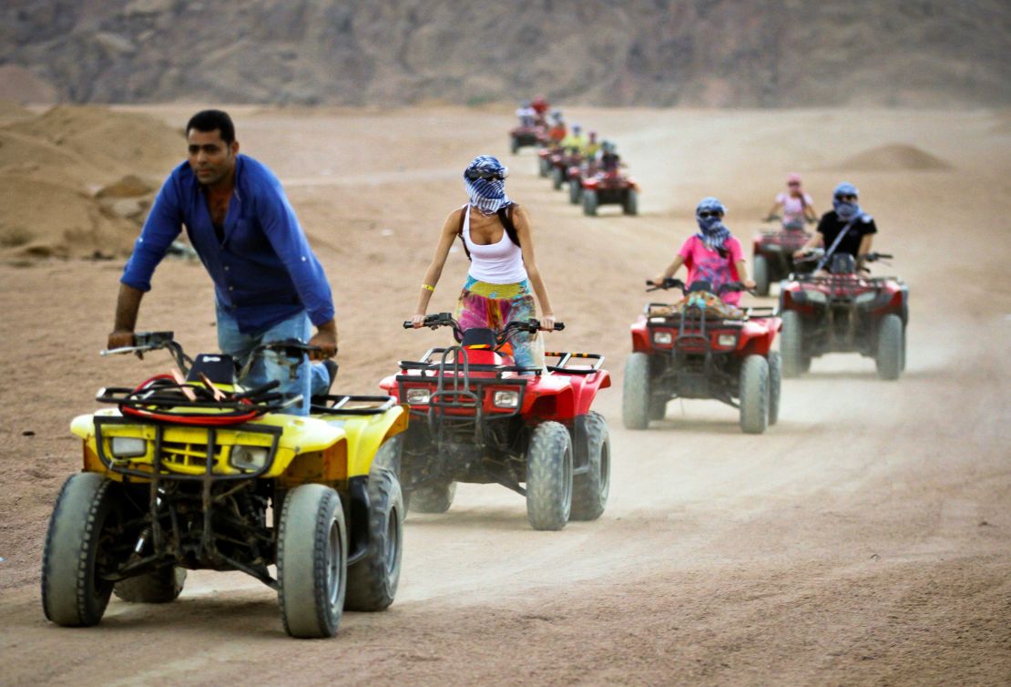 Tourists ride quad-bikes during part of a desert safari trip in Egypt.