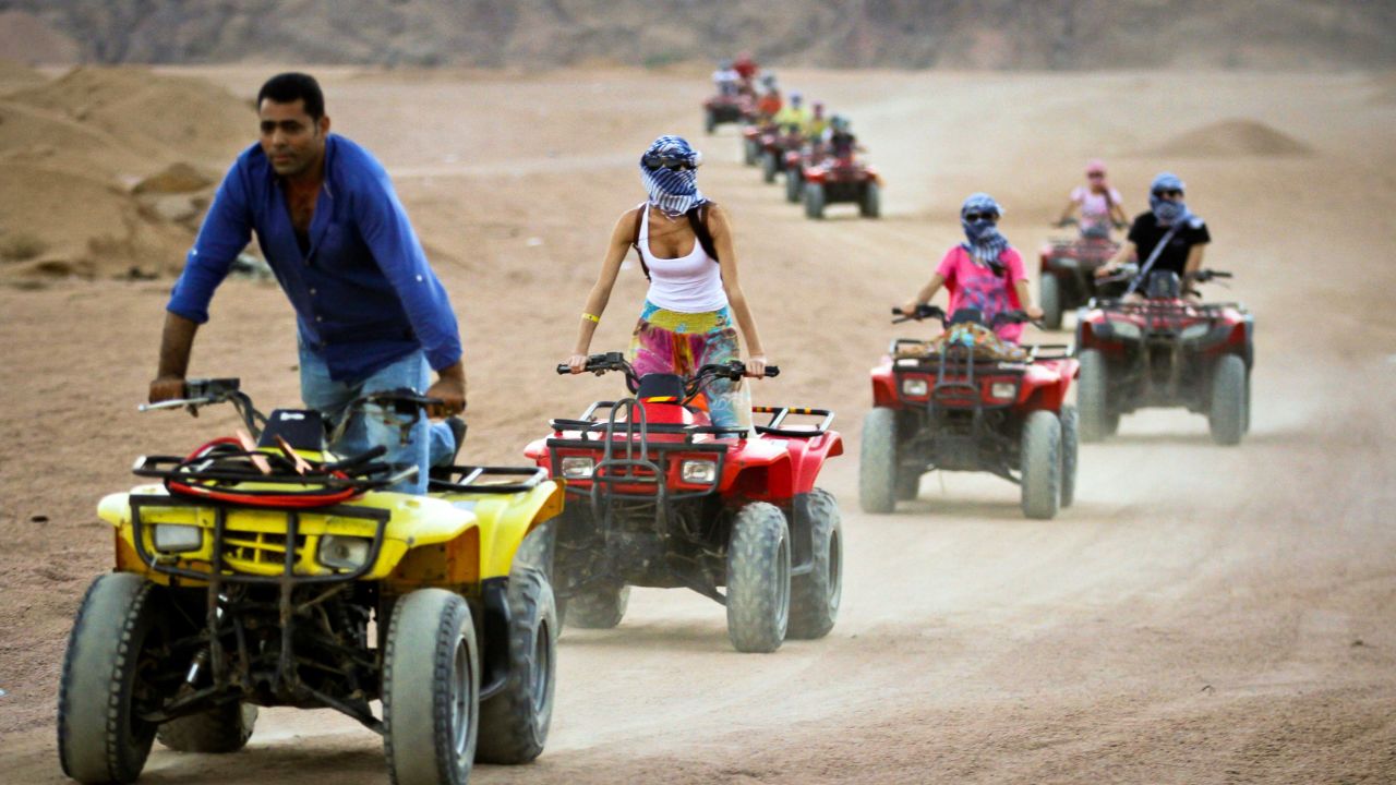 Tourists ride quad-bikes during part of a desert safari trip in Egypt.