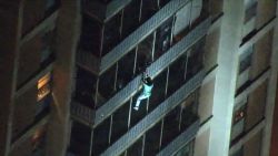 man climbs out of building