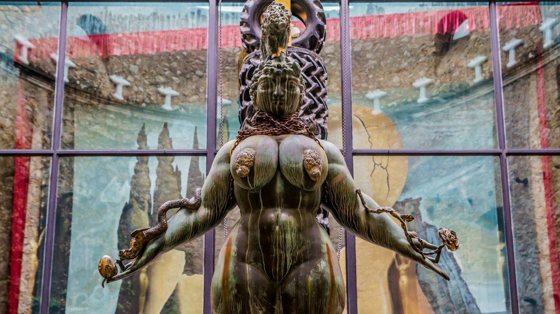 In the courtyard, a bronze statue by Austrian sculptor Ernst Fuchs stands atop Dali's Cadillac.