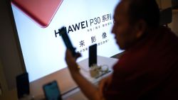 A customer looks at a smartphone at a Huawei retail store in Beijing on May 23, 2019. - Chinese telecom giant Huawei says it could roll out its own operating system for smartphones and laptops in China by the autumn after the United States blacklisted the company, a report said on May 23. (Photo by FRED DUFOUR / AFP)        (Photo credit should read FRED DUFOUR/AFP/Getty Images)
