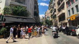People stand on street corners in the Kolonaki neighborhood in central Athens after an earthquake struck the areas on Friday, July 19.