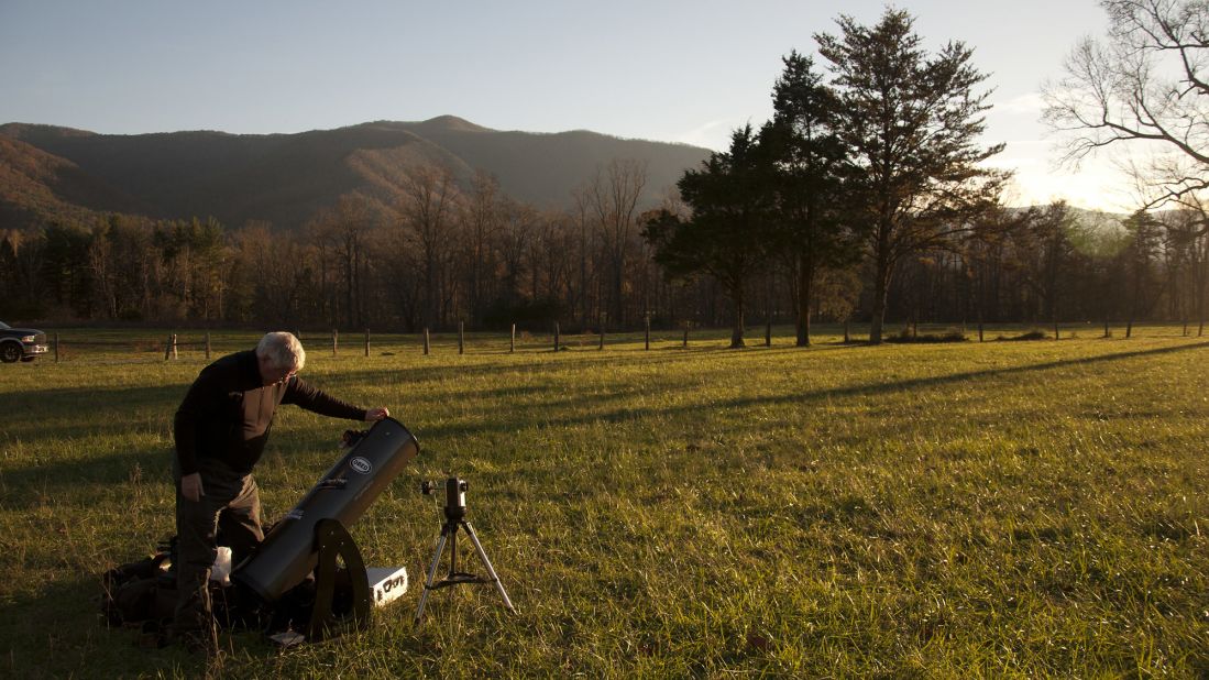 <strong>Look to the stars:</strong> As sunset approaches, an astronomer sets up a telescope. The park, far from urban light pollution, is a good place from which to observe the night sky.