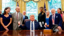 President Donald Trump, accompanied by Apollo 11 astronauts Micheal Collins, second from left, and Buzz Aldrin, second from right, with Vice President Mike Pence and first lady Melania Trump, speaks during a photo opportunity commemorating the 50th anniversary of the Apollo 11 moon landing, in the Oval Office of the White House, Friday, July 19, 2019, in Washington. (AP Photo/Alex Brandon)