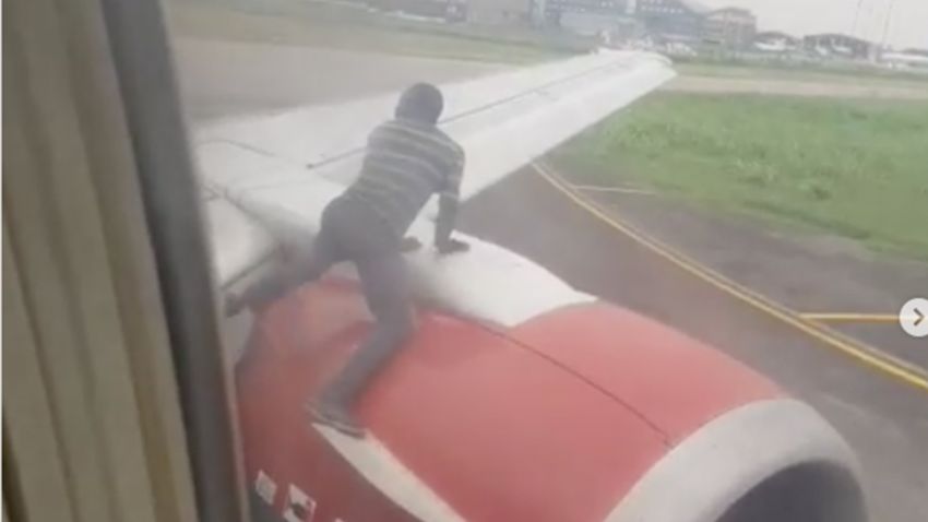 man climbs plane nigeria intl 0719