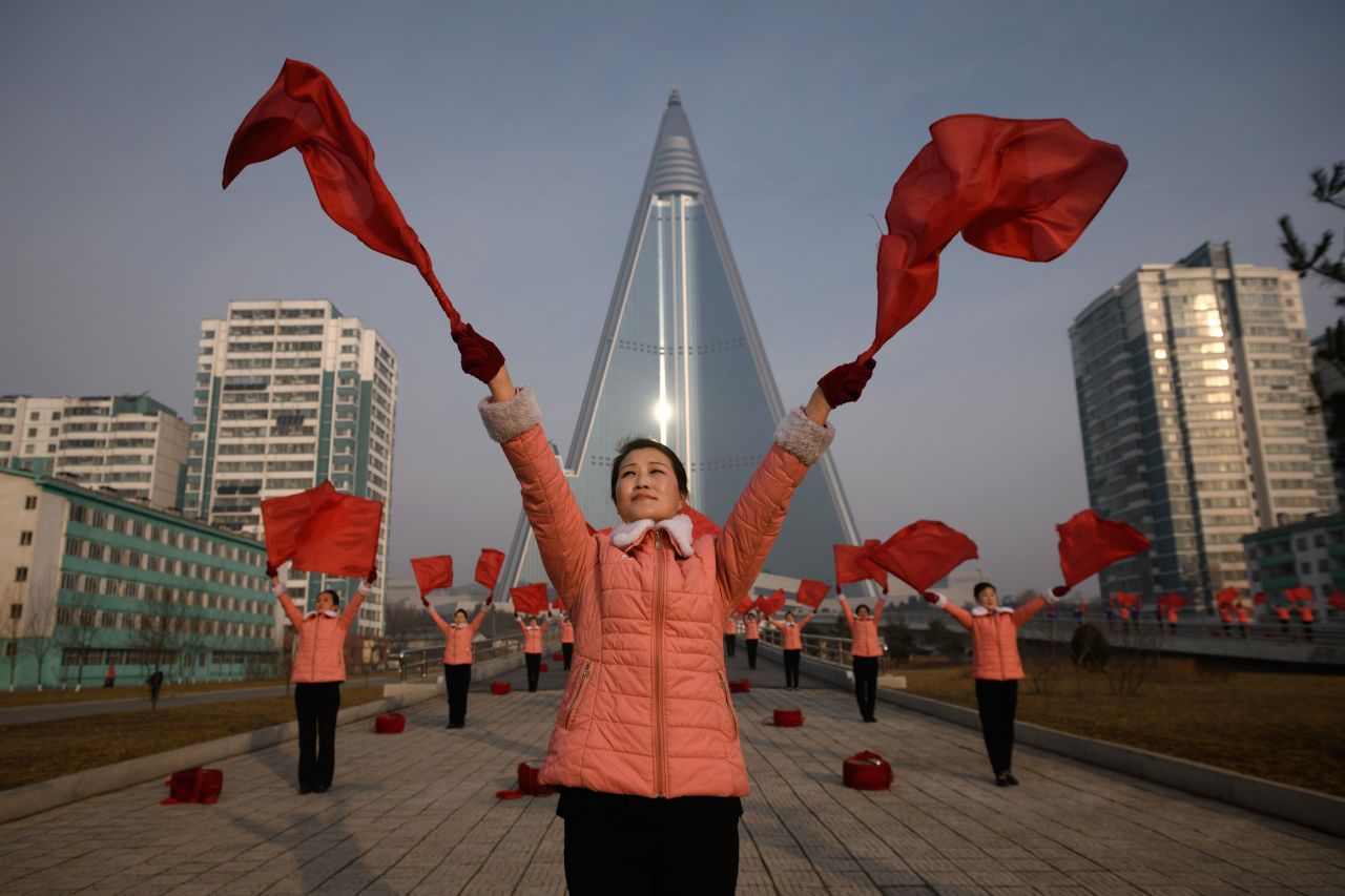 Members of a Socialist Women's Union propaganda troupe perform a dance in front of the Ryugyong hotel in 2019.