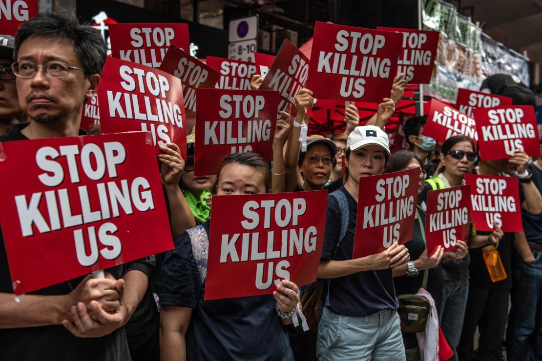 Protesters hold placards during a demonstration against the now-suspended extradition bill on June 16, 2019 in Hong Kong. 