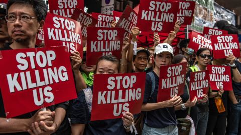 Protesters hold placards during a demonstration against the now-suspended extradition bill on June 16, 2019 in Hong Kong. 
