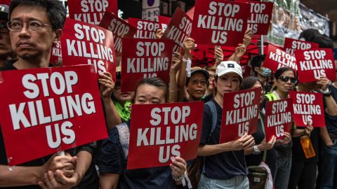 Protesters hold placards during a demonstration against the now-suspended extradition bill on June 16, 2019 in Hong Kong.