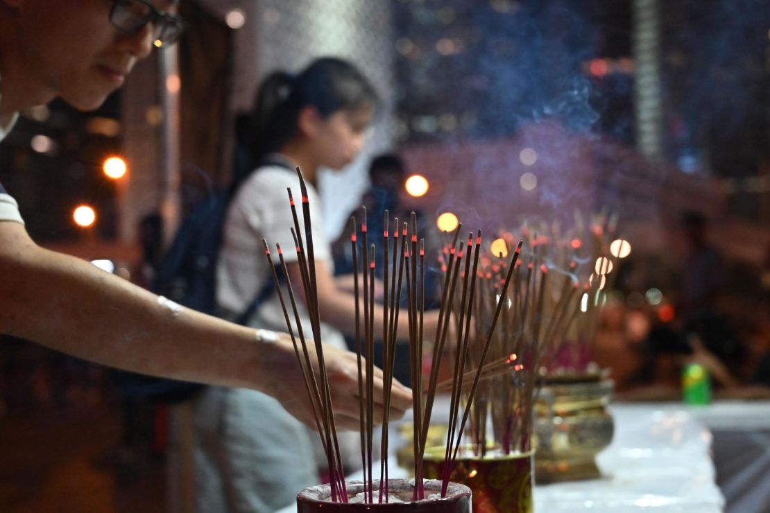 People offer prayers during a vigil in Hong Kong on July 6, 2019, in memory of the four protesters who died.