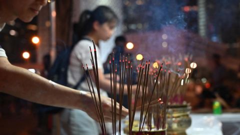 People offer prayers during a vigil in Hong Kong on July 6, 2019, in memory of the four protesters who died.