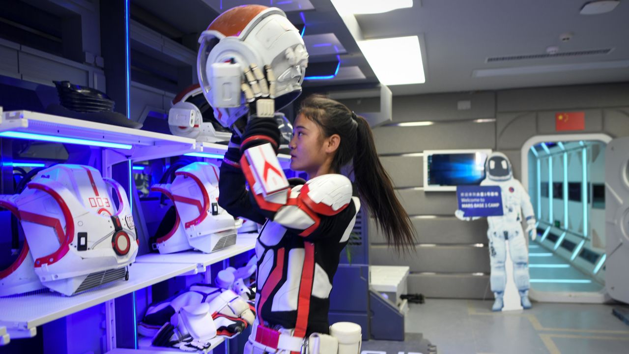 A guide wearing a spacesuit puts on a helmet at "Mars Base 1", a C-Space Project, in the Gobi desert, some 40 kilometres from Jinchang in China's northwest Gansu province on April 17.