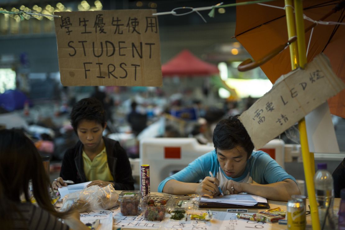 Students do their homework at a study area occupied as part of the Umbrella Movement on October 10, 2014, in Hong Kong.