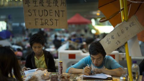 Students do their homework at a study area occupied as part of the Umbrella Movement on October 10, 2014, in Hong Kong.