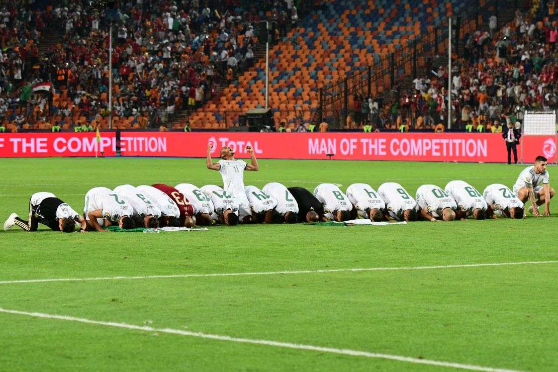 Algerian players pray as they celebrate after winning the 2019 Africa Cup of Nations.