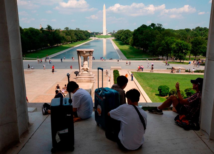 People rest in the shade at the Lincoln Memorial on the National Mall in Washington, DC, on July 19.
