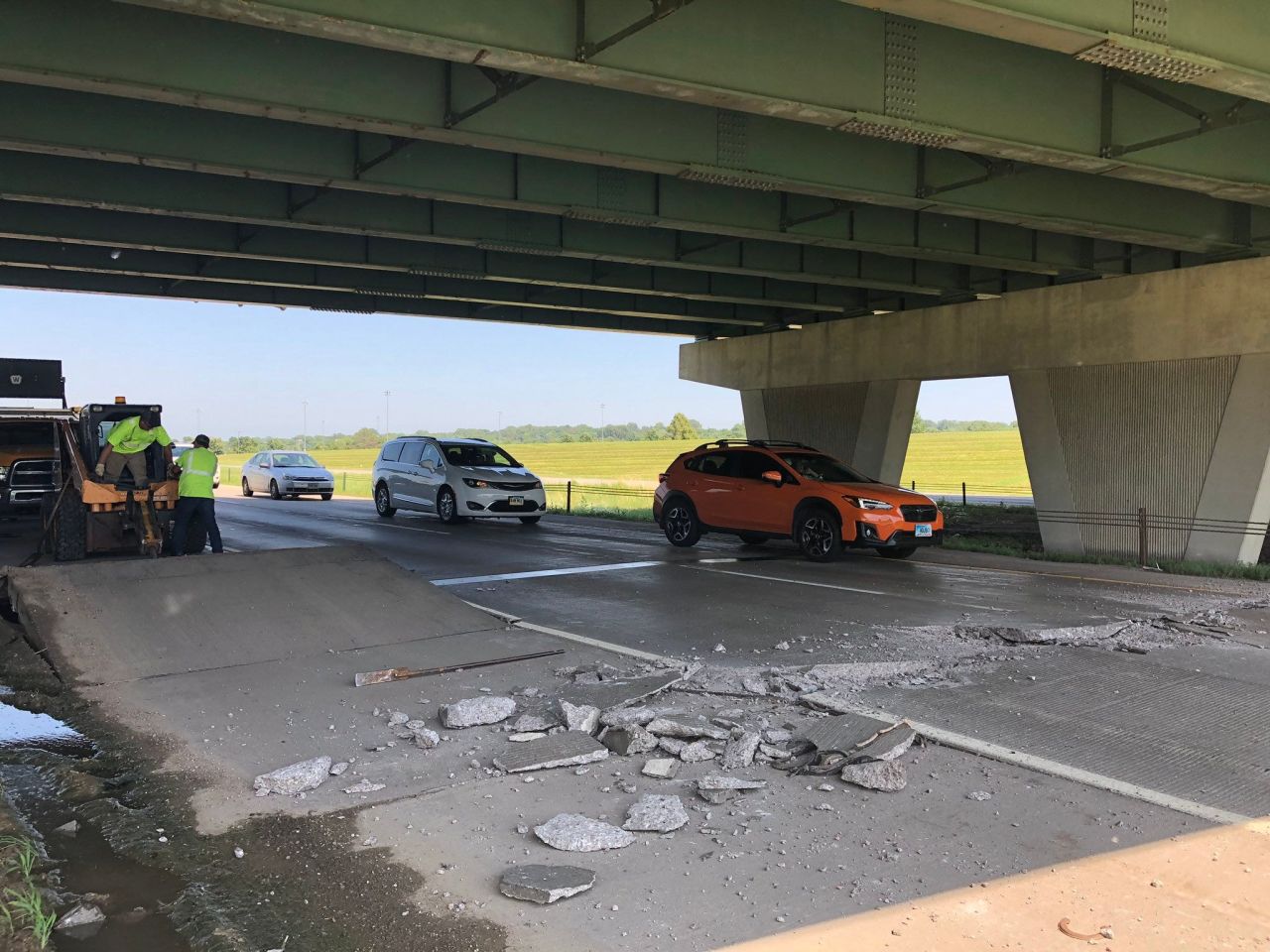 Vehicles drive over a buckled road, caused by the heat, on Interstate 229 under the Western Avenue bridge in Sioux Fall, South Dakota, on July 19.