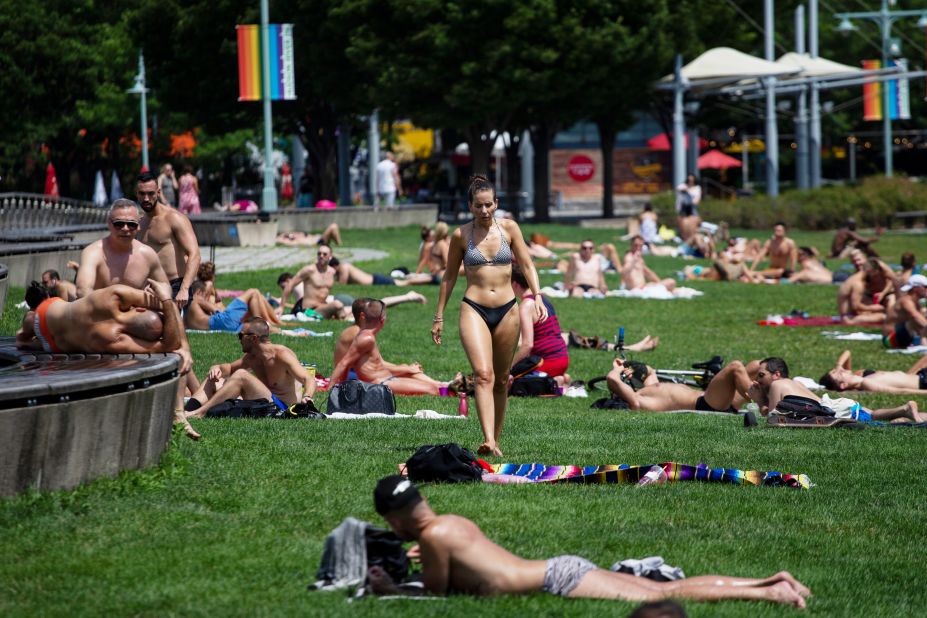 People sunbathe at Pier 45 in New York on Saturday, July 20.