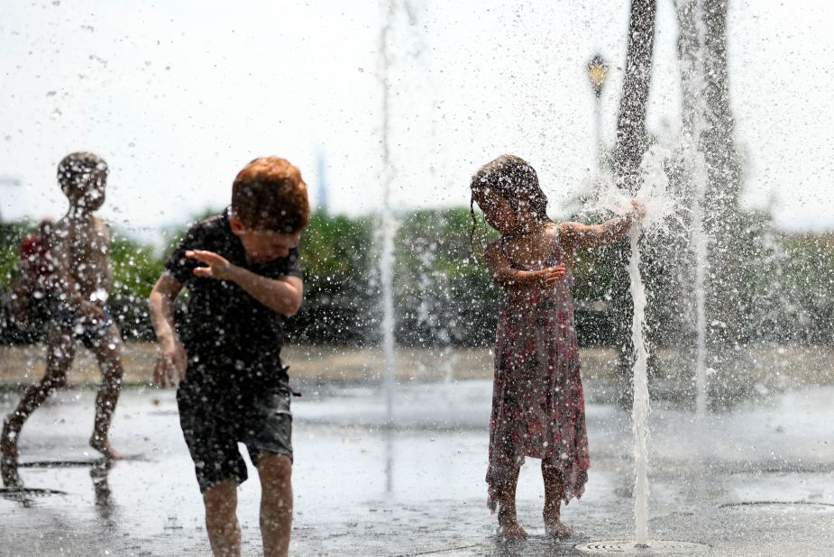 Children cool down as they play in a public fountain in New York on July 19.
