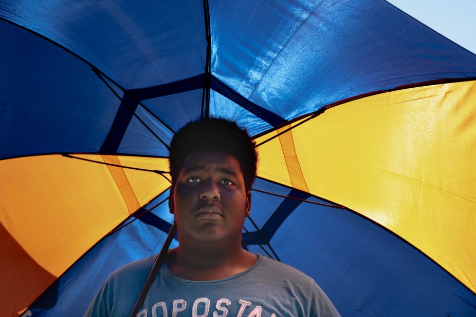 Marcus Rimson, 16, waits for the bus after work in Kalamazoo, Michigan, on Thursday, July 18.