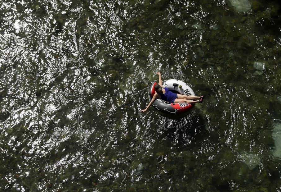 A woman floats in a tube on the Comal River, in New Braunfels, Texas, on July 18.