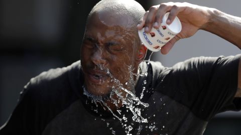 Baltimore Orioles outfielder Keon Broxton douses himself with water prior to a baseball game against the Boston Red Sox in Baltimore, Maryland, on Friday, July 19.