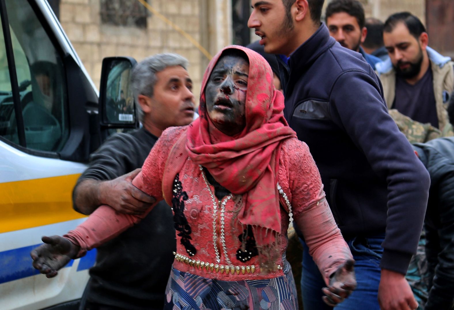 Syrian men help a wounded woman covered in dust following a strike in the town of Khan Sheikhoun on February 15, 2019. "Anas al-Dyab is more than a friend, he's a colleague and my best friend. We spent a lot of time together. He was the closest person to me and was more than a brother," Kutini added.